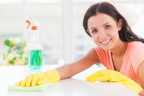 Carpet cleaning technician preparing equipment with safety awareness