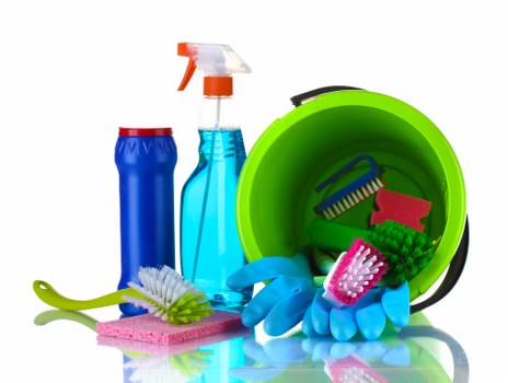 Cleaner wearing PPE while working safely in a property